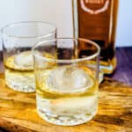Whiskey poured into a highball glassware with round ice cube.