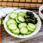 Japanese sunomono cucumber salad served in a bowl topped with toasted sesame seeds.