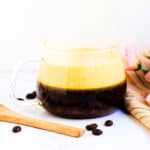 Vietnamese style egg coffee served in a glass mug.