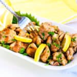 Lemon BBQ chicken being picked up with a fork.