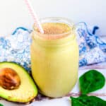 Chocolate avocado smoothie served in a mason jar with a straw.