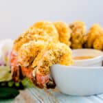 Baked coconut coated shrimp served on rim of bowl with a spicy mayo dipping sauce.