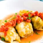 Japanese style roll cabbage topped with fresh parsley served in a white bowl.