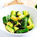Spicy garlic cucumber salad served in a white bowl.