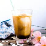Coconut coffee smoothie served in a glass with a straw.