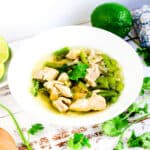 Peruvian chicken soup, Aguadito de Pollo, served in a white bowl.