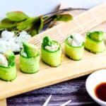 Cream cheese California roll served on a wooden serving plate.