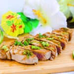 Hawaiian inspired glazed seared ahi tuna served on a wooden serving board.