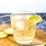 Ginger Whiskey Soda served in a glass cup with a wedge of lime.