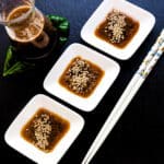 Hibachi ginger sauce recipe served in a white sauce bowl with toasted sesame seeds on top.