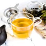 Green tea poured in a cup, top down shot.