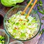 Japanese cabbage salad being picked up with a pair of chopsticks.