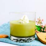 Homemade matcha jello inside a glass cup.