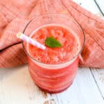 Homemade watermelon slushie in a cup with a straw