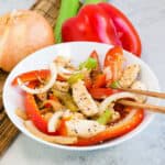 Black pepper chicken served in white bowl.