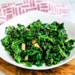 Garlic kale stir fry served on a white plate.