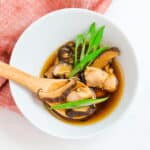 Japanese mushroom soup served in a bowl topped with green onions.