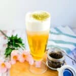 Home brewed green tea topped with cream cheese foam served in a glass.