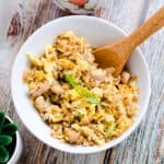 Garlic chicken fried rice served in a rice bowl topped with green onion, top down angle.