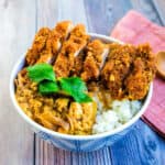 Katsu don served in a bowl topped with mitsuba.