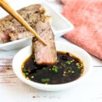 Steak being dipped into ponzu Japanese steak sauce.