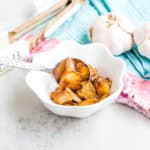 Fried sliced garlic being picked with a spoon.
