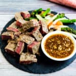 At home hibachi style seared steak served with ginger sauce and vegetables.