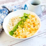 Japanese scrambled egg rice bowl served with a spoon.