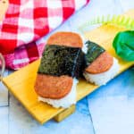 Air fried spam musubi on a wooden plate.