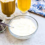 Cheese foam cap being scooped out with a spoon.