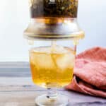 Oolong tea being served in a cup with ice.