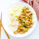 Pork ginger stir fry served with shredded cabbage and rice.