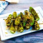 Grilled okra skewers served on a plate.
