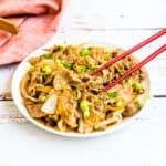 Pork and onion stir fry served on a plate.