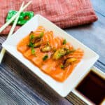 Garlic ponzu salmon served on a plate.