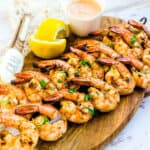 Grilled shrimp on a skewer served with old bay aioli sauce.