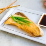Japanaese shioyaki yellowtail served on a plate.
