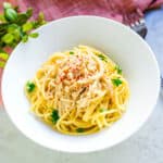 Enoki mushroom pasta served on a plate.