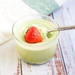 Matcha green tea pudding being scooped out with a spoon.