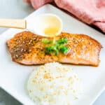Miso butter being drizzled on top of a seared salmon.