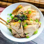 Chashu rice bowl being picked up with a chopstick.