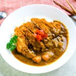 Tonkatsu sliced and served with rice and curry.