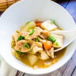 Miso pork stew being scooped up with a spoon.
