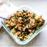 Salmon sushi bake being scooped out with a spoon.