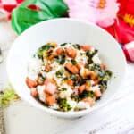 Spam rice served in a bowl topped with crushed roasted seaweed.