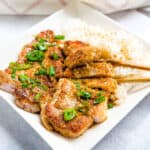 Japanese pork chops being picked up with a chopstick.