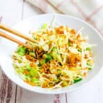 Ramen cabbage salad being picked up with chopsticks.