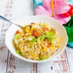Bacon fried rice being scooped up with a spoon.
