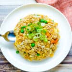 Japanese style garlic fried rice being scooped out with a spoon.