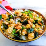 Shrimp poke bowl being scooped with a spoon.